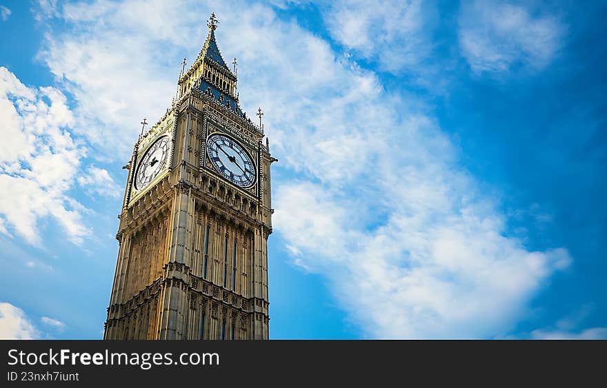 Iconic Big Ben Clock Tower Against a Vibrant Blue Sky with Clouds