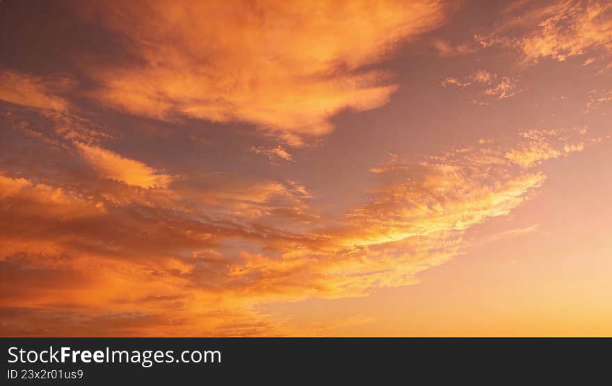 Golden Hour Sunset Sky with Warm Orange Hues and Cloudy Wisps - AI-generated illustration