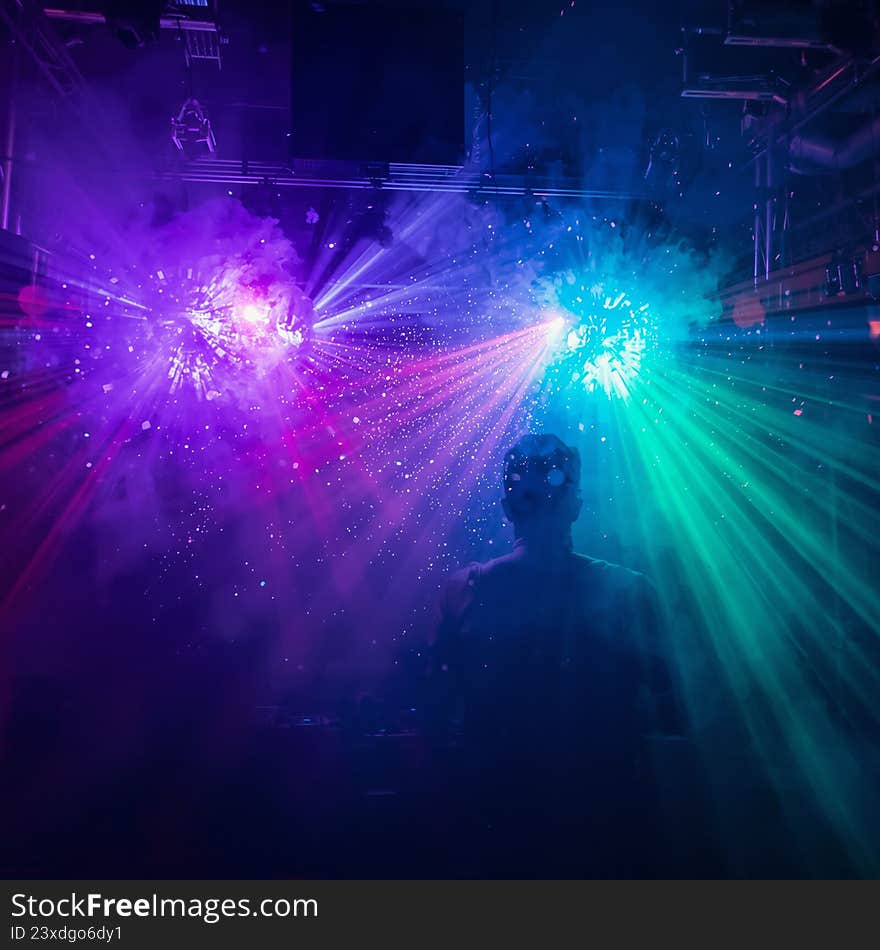 Vibrant abstract background featuring powerful neon laser beams in blue, pink, and purple colors bursting through dark smoke and p
