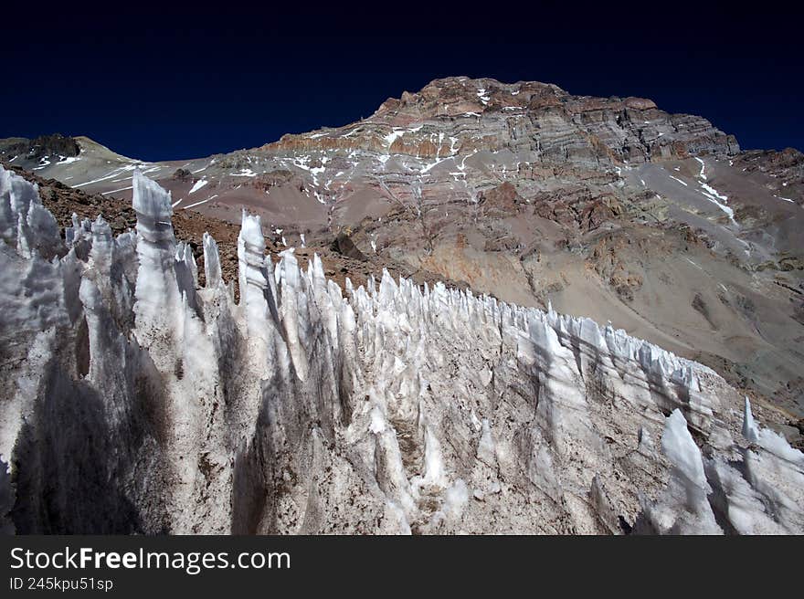The enchanting beauty of the snowy mountains. The view of snow and rocks on the mountain tops