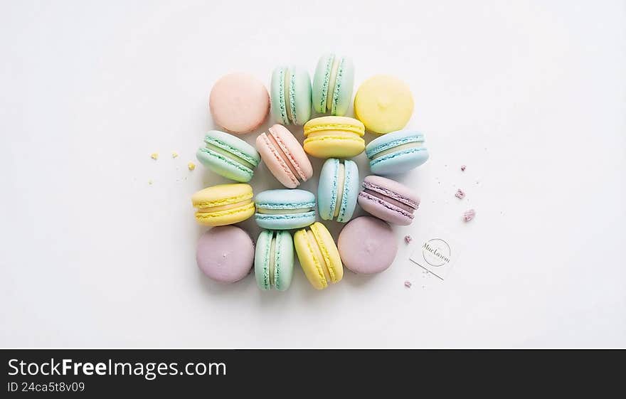 Assorted macarons in pastel colors, top view, white background, high key lighting, e-commerce food photo