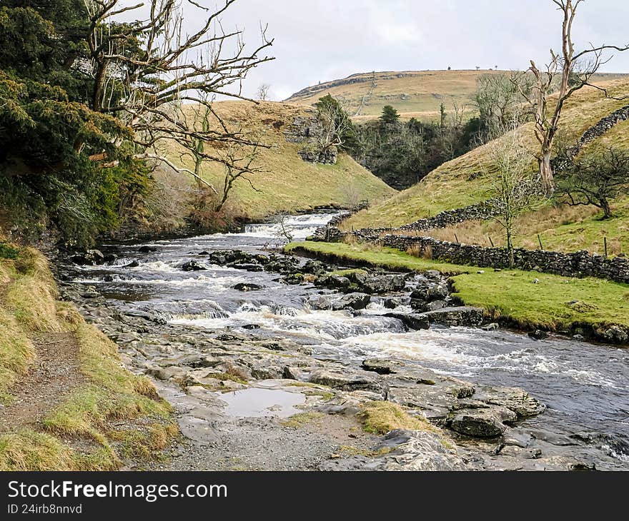 Scenic view of a waterfall along the Ingleton Waterfalls Trail in Yorkshire, England. Natural landscape featuring cascading water, mossy rocks, forest surroundings, and a peaceful outdoor atmosphere. Popular hiking destination showcasing British nature, ideal for travel, nature. Scenic view of a waterfall along the Ingleton Waterfalls Trail in Yorkshire, England. Natural landscape featuring cascading water, mossy rocks, forest surroundings, and a peaceful outdoor atmosphere. Popular hiking destination showcasing British nature, ideal for travel, nature.