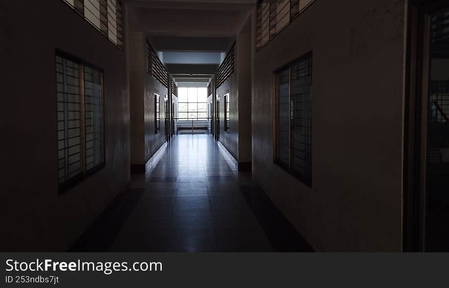 A ray of hope coming through the window inside a dark building