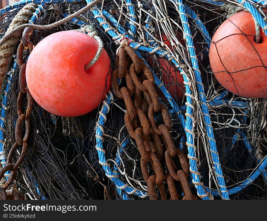 Commercial fishing equipment piled up, showing wear and tear