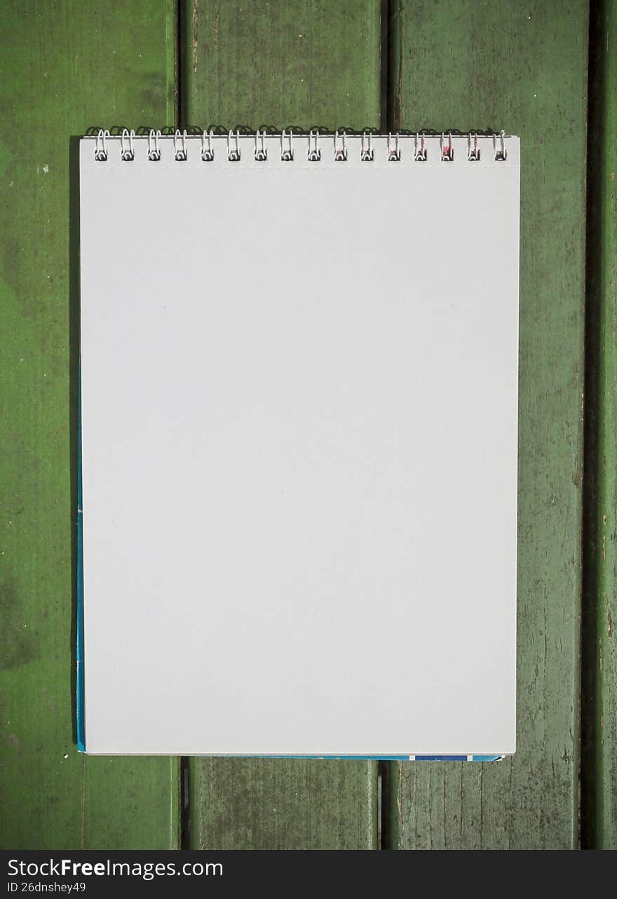 Sheet of the album on a wooden green paint background, calendar or presentation page mock up