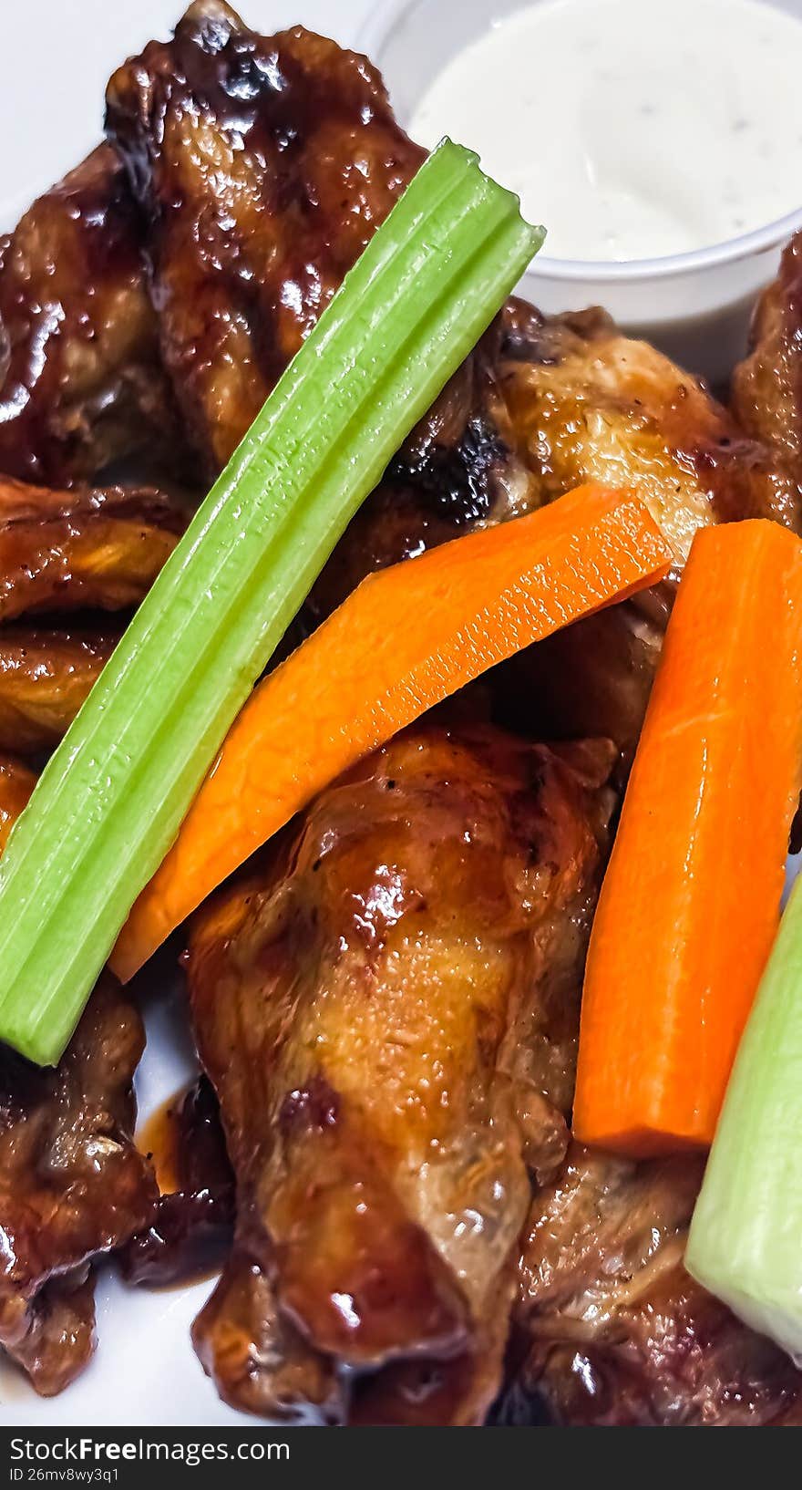 A mouth-watering study of texture and light. These wings are tossed in a rich, amber honey glaze that catches the warm indoor glow while the snow falls outside. Garnished with toasted sesame seeds and fresh scallions, this shot perfectly captures the soul-warming comfort of a winter night in the Ottawa Valley.