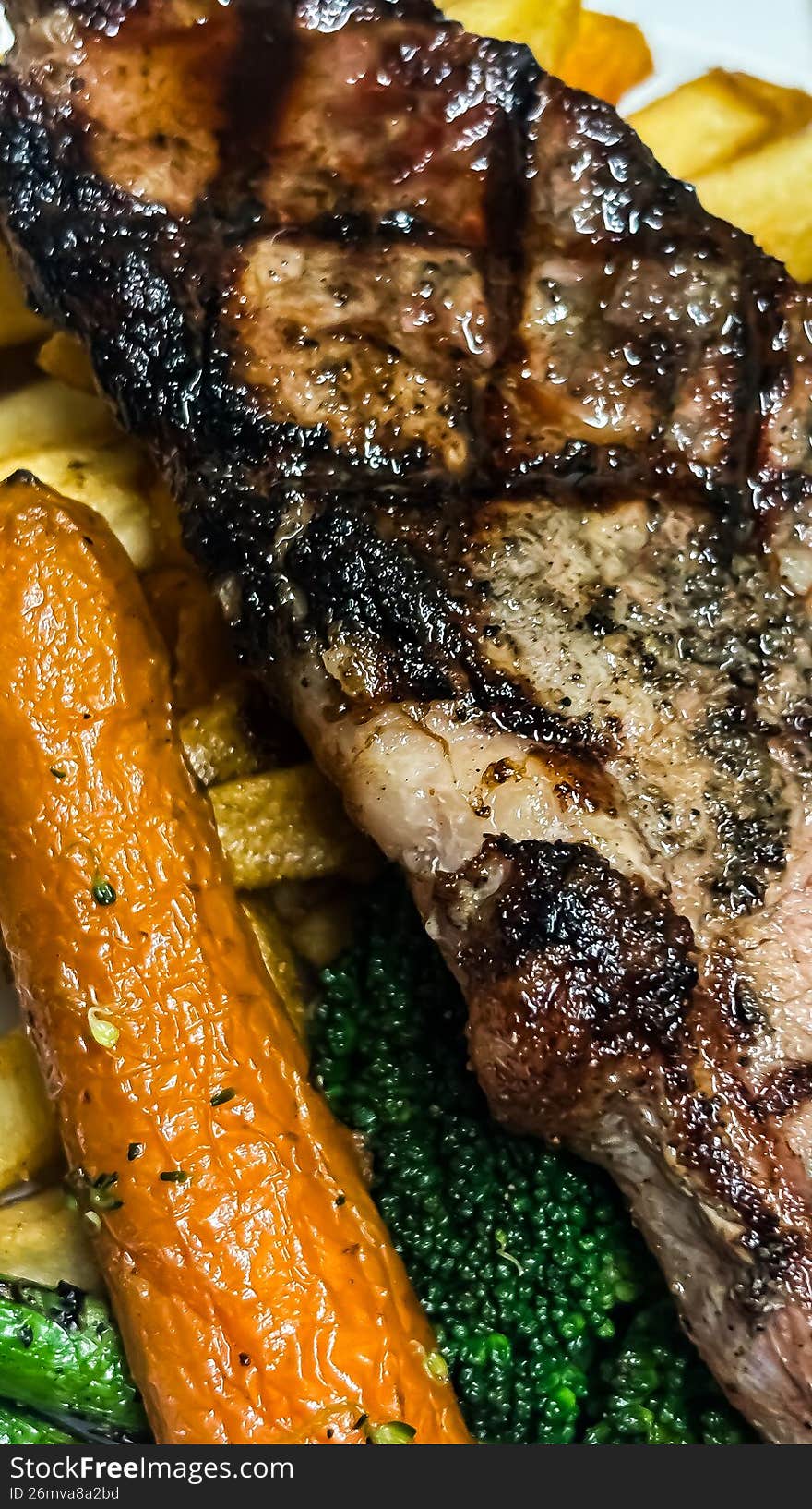 A robust celebration of winter textures. This shot features a perfectly seared beef steak accompanied by a charred medley of seasonal vegetables�think vibrant asparagus, blistered cherry tomatoes, and honey-glazed carrots. It�s a visual testament to the idea that eating well doesn't stop when the temperature drops.